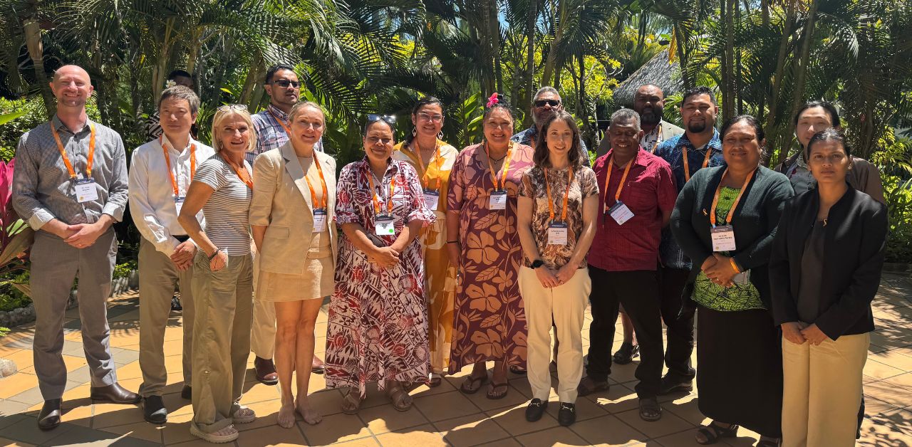 A photo showing the Partnerships for Life Western Pacific Region group standing outside in front of trees