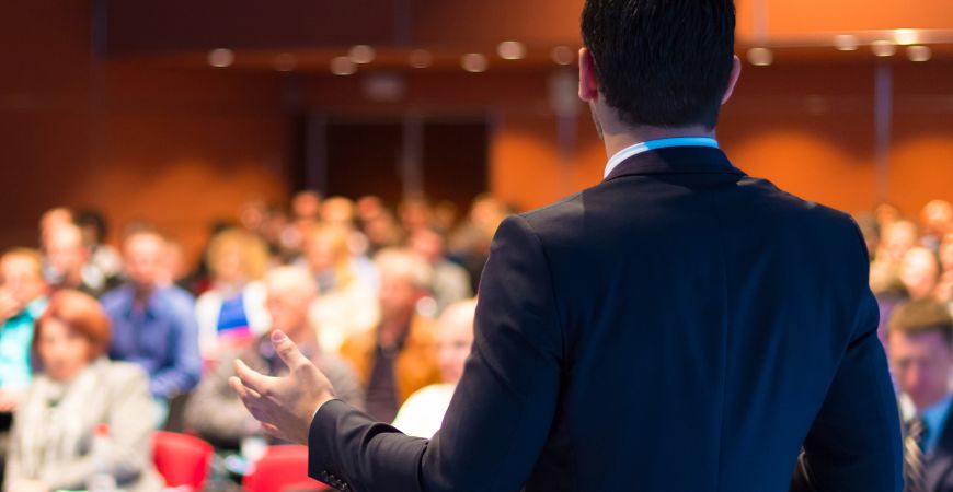 An image showing a conference room full of delegates