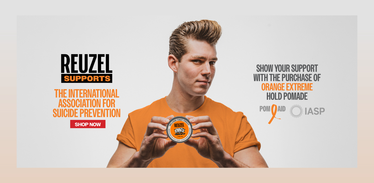 An image showing a man holding a pot of Reuzel hair product for World Suicide Prevention Day